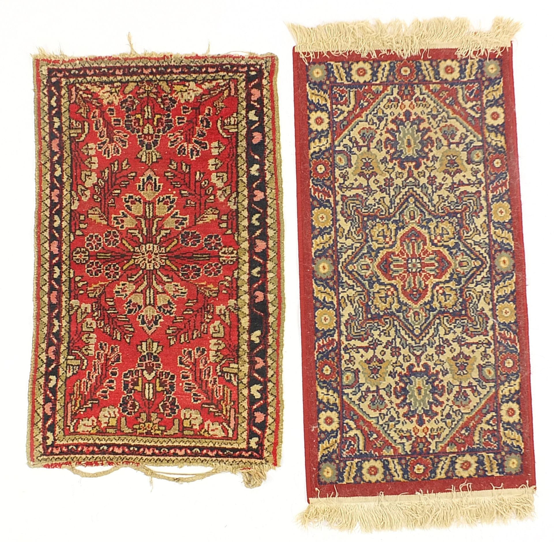 Two small red ground rugs, the largest 100cm x 50cm