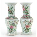 Pair of Chinese porcelain vases hand painted in the famille rose palette with flowers, each 25cm