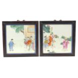 Pair of Chinese porcelain panels housed in hardwood frames, each hand painted in the famille rose