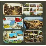 Local Eastbourne postcards arranged in an album including Beachy Head and Carpet Gardens