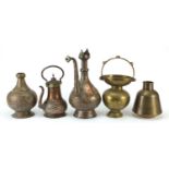 Middle Eastern metalware including coffee pot, spittoon and hookah bases, the largest 36cm high