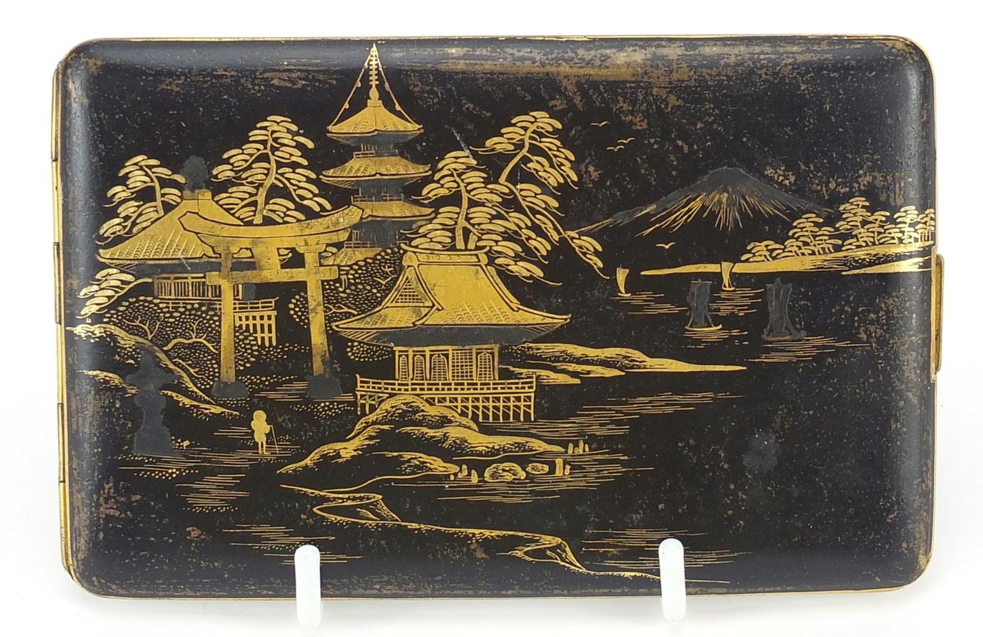 Japanese damascene cigarette case by Fujii Yoshitoyo, engraved with pagodas and a dragon, 12.5cm