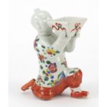 Chinese porcelain figural candle holder hand painted with flowers, 15cm high