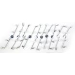 Nine contemporary adjustable chromed four branch wall lights, each 78cm in length