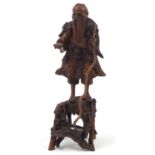 Chinese root wood carving of an elder holding a staff, 51cm high