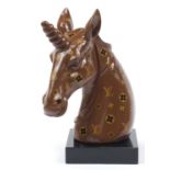 Louis Vuitton design unicorn bust raised on a square black glass base, 47cm high Appears to be in