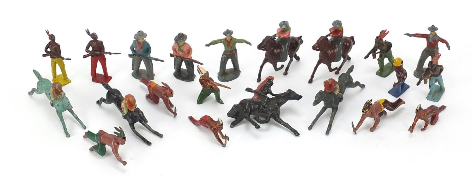 Vintage hand painted lead figures including cowboys, Indians and jockeys on horseback, the largest