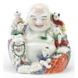 Chinese porcelain figure of Buddha with children, impressed character marks to the base, 25cm high