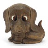 Novelty carved Black Forest clock with moving eyes in the form of a dog, 11.5cm wide