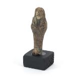 Egyptian style ushabti raised on a wooden base, overall 9cm high