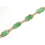 9ct gold bracelet set with six Chinese carved green jade panels, 20cm in length, 13.6g