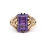 Gold coloured metal purple stone ring, the band stamped 333, size N/O, 3.7g