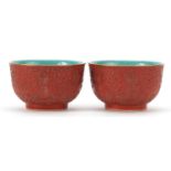 Pair of Chinese faux cinnabar lacquer porcelain bowls, four figure character marks to the bases,