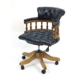 Lightwood framed Captain's chair with blue leather button back upholstery, 90cm high