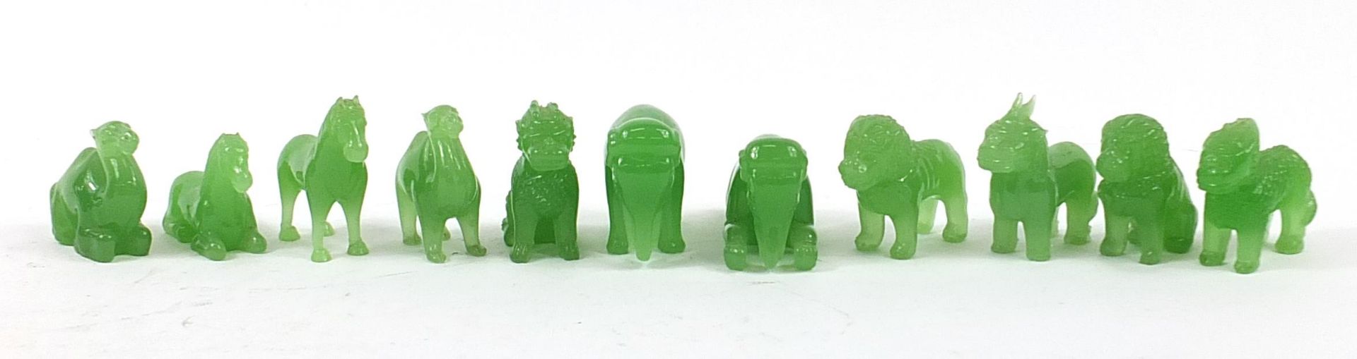 Eleven Chinese green glass animals including camels and horses, the largest 10cm in length