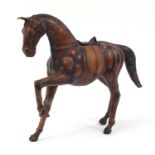 Large leather covered horse in the style of Liberty, 50cm in length