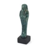 Egyptian style ushabti raised on a wooden base, overall 13cm high