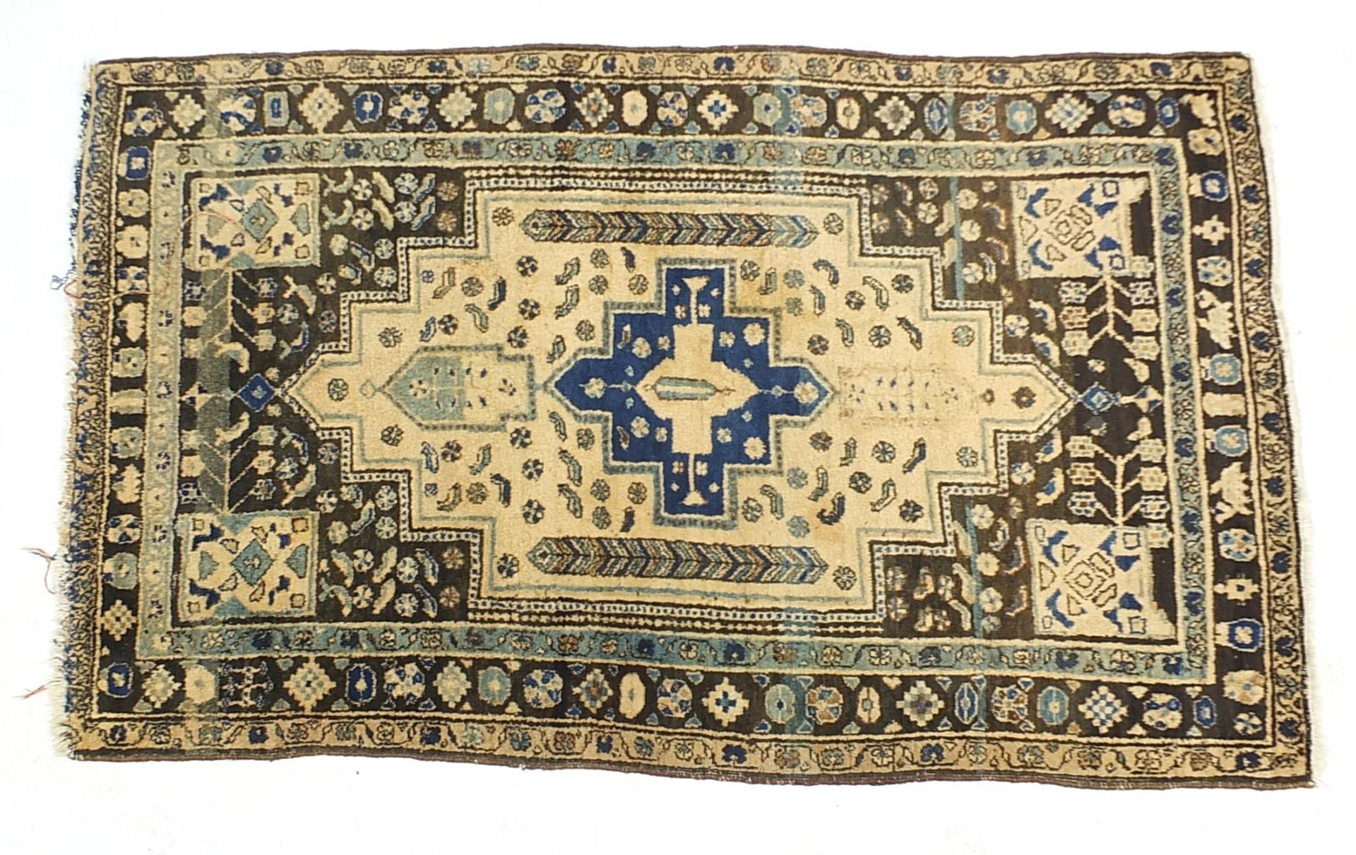 Brown, blue and beige ground rug with all over geometric design, 205cm x 128cm