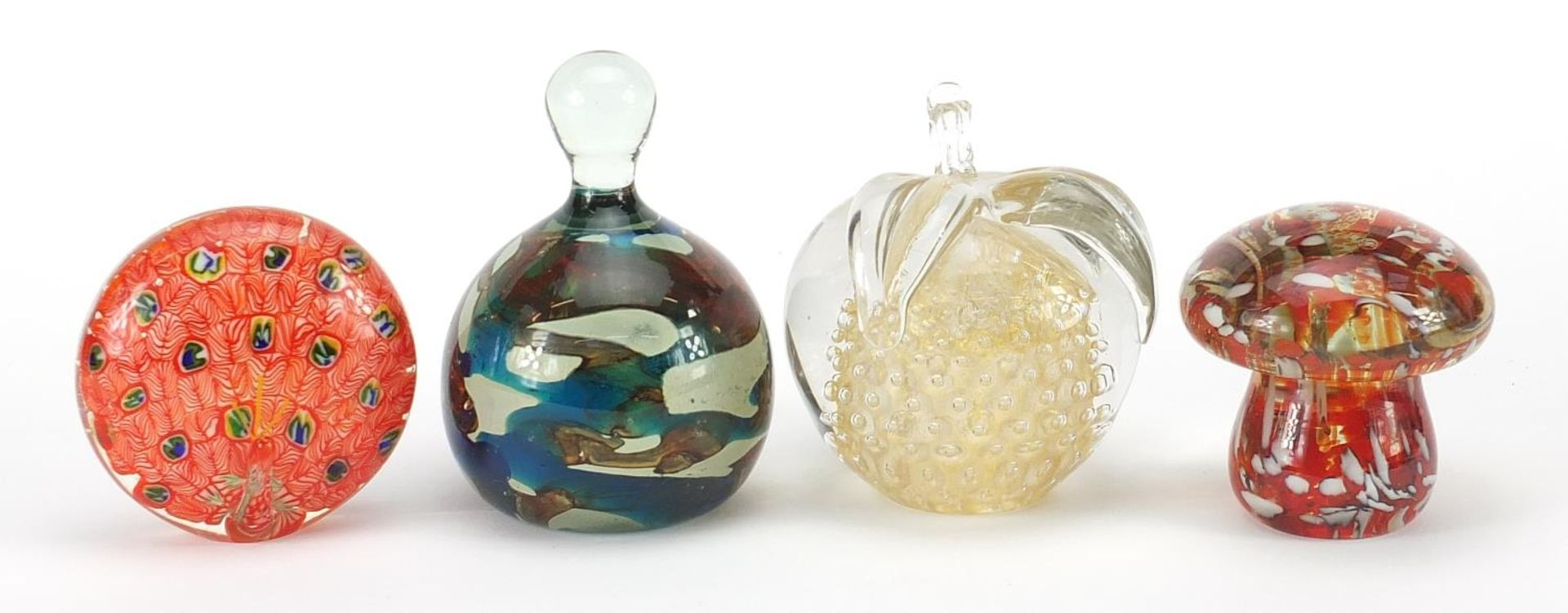 Four glass paperweights including Mdina, the largest 12cm high