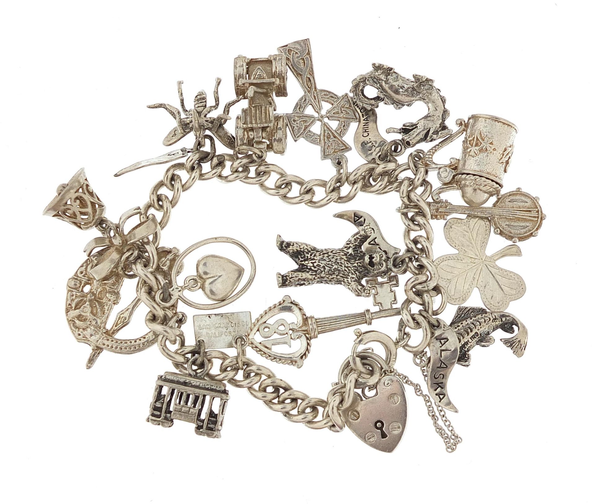 Silver charm bracelet with a selection of mostly silver charms, 16cm in length, 54.5g