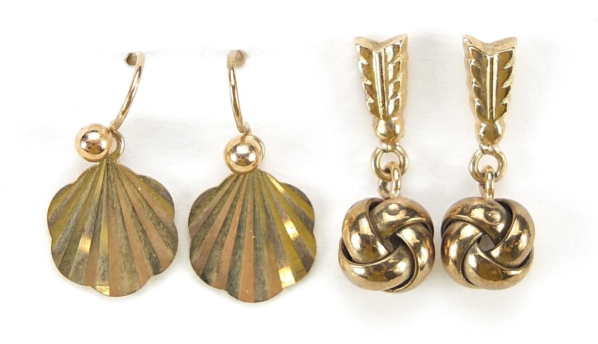Pair of 9ct gold shell shaped earrings and a pair of unmarked gold drop earrings, (tests as 9ct