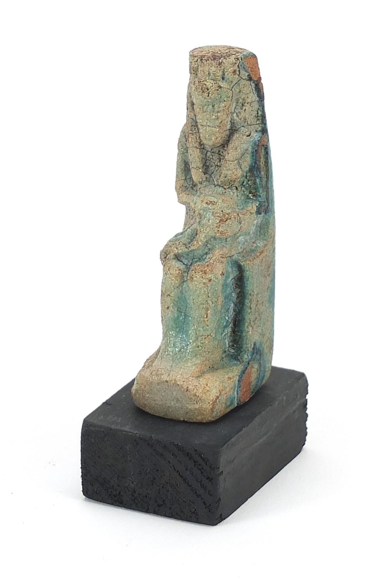 Egyptian style stone figure raised on a wooden base, overall 10cm high