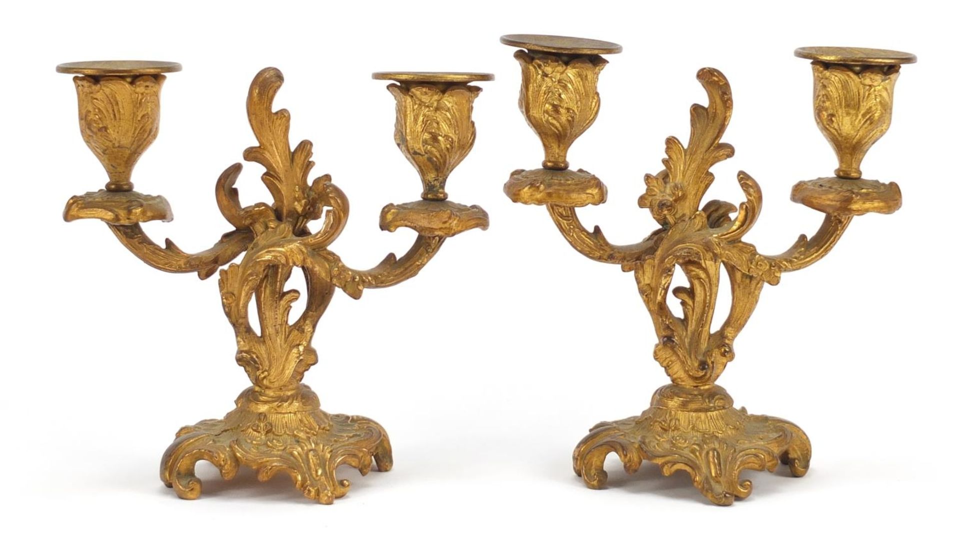 Pair of Rococco style gilt metal two branch candlesticks, each 15cm high Both are in generally