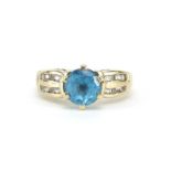 9ct gold blue topaz solitaire ring set with white sapphires to the shoulders, size N, 4.8g