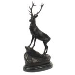 Large patinated bronze stag raised on a shaped marble base, 74cm high