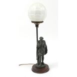 Patinated spelter Shakespeare design table lamp with globular glass shade raised on a circular oak