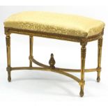 Large French design gilt stool with gold floral upholstery, 68cm H x 93cm W x 50cm D