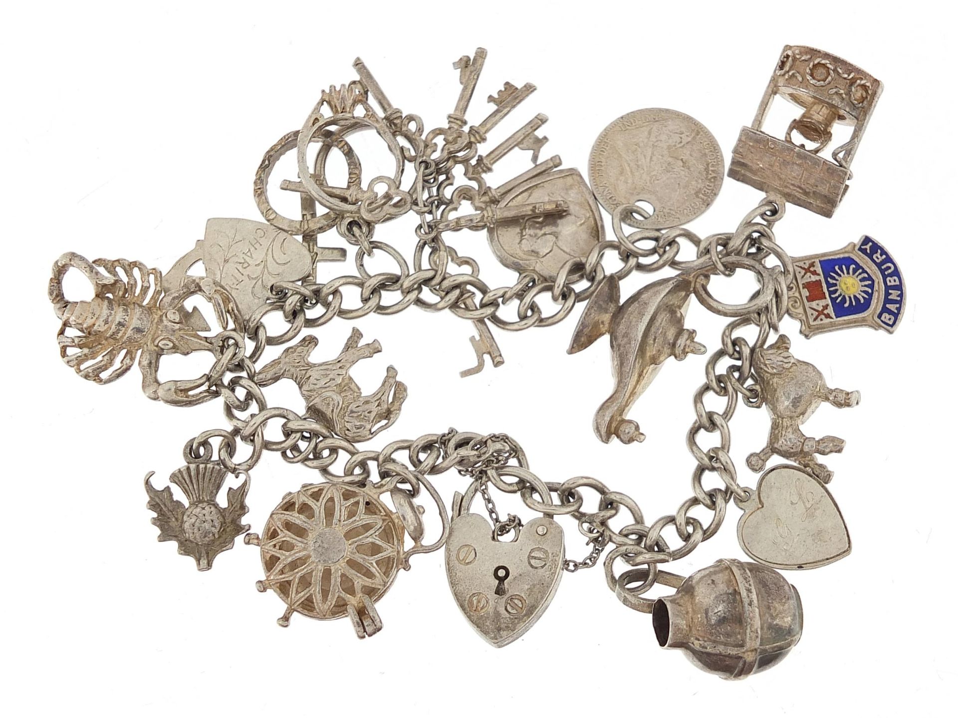 Silver charm bracelet with a selection of mostly silver charms, 49.0g