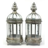 Pair of ornate silvered metal lanterns with glass panels, 61cm high Both appear to be in good
