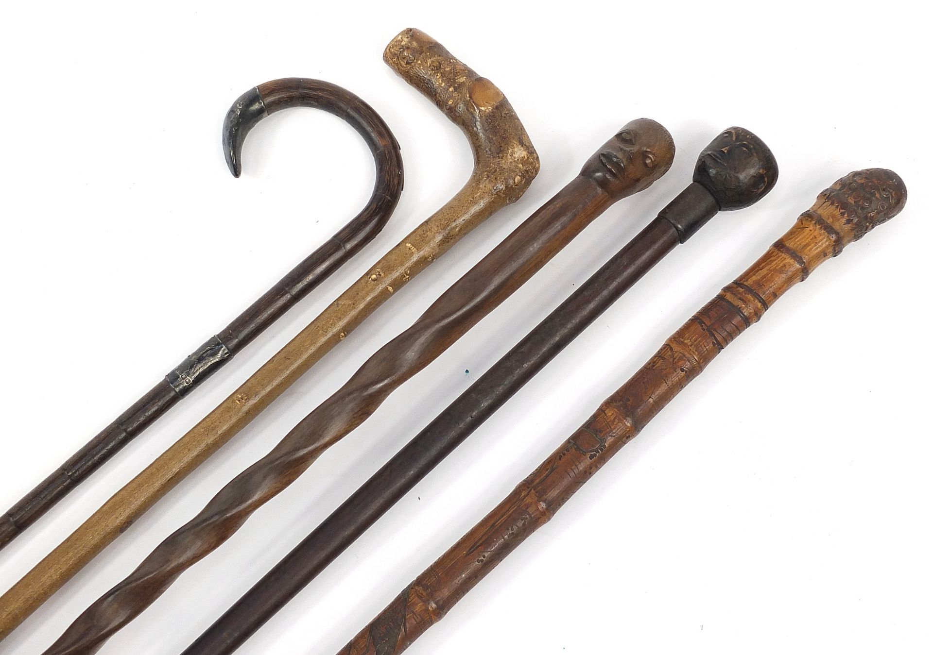 Five walking sticks, including a Chinese bamboo example with silver mounts