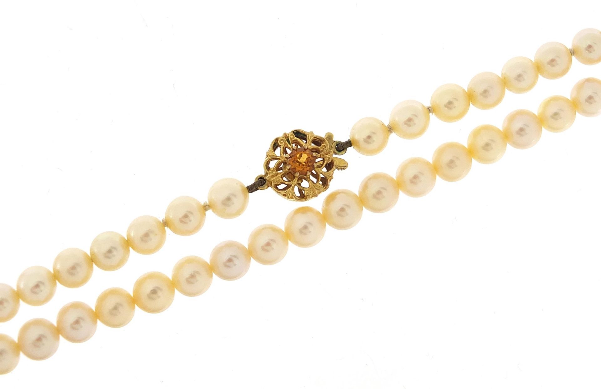 Single string pearl necklace with 9ct gold citrine clasp housed in a K L Brown & Son Ltd Sheffield
