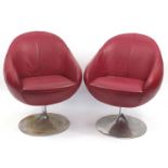 Pair of vintage egg type tub chairs, signs of paper labels to the underside, each 78cm high