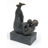 Mid century style patinated bronze study of a mother and child raised on a rectangular block base,