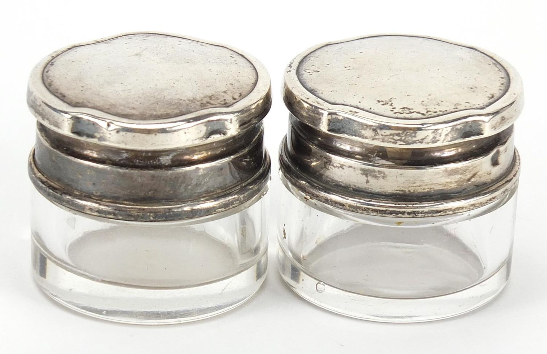 Walker & Hall, pair of circular cut glass jars with silver lids, Birmingham 1939, 3.5cm high x 3.8cm