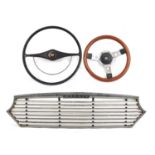 Two vintage motor vehicle steering wheels and a Morris grille comprising Mountney and Jaguar, the
