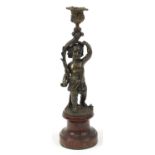 Patinated bronze Putti candlestick with simulated marble base, 33cm high
