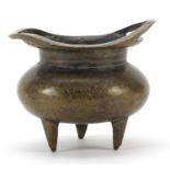 Chinese patinated bronze tripod incense burner with twin handles, character marks to the base,