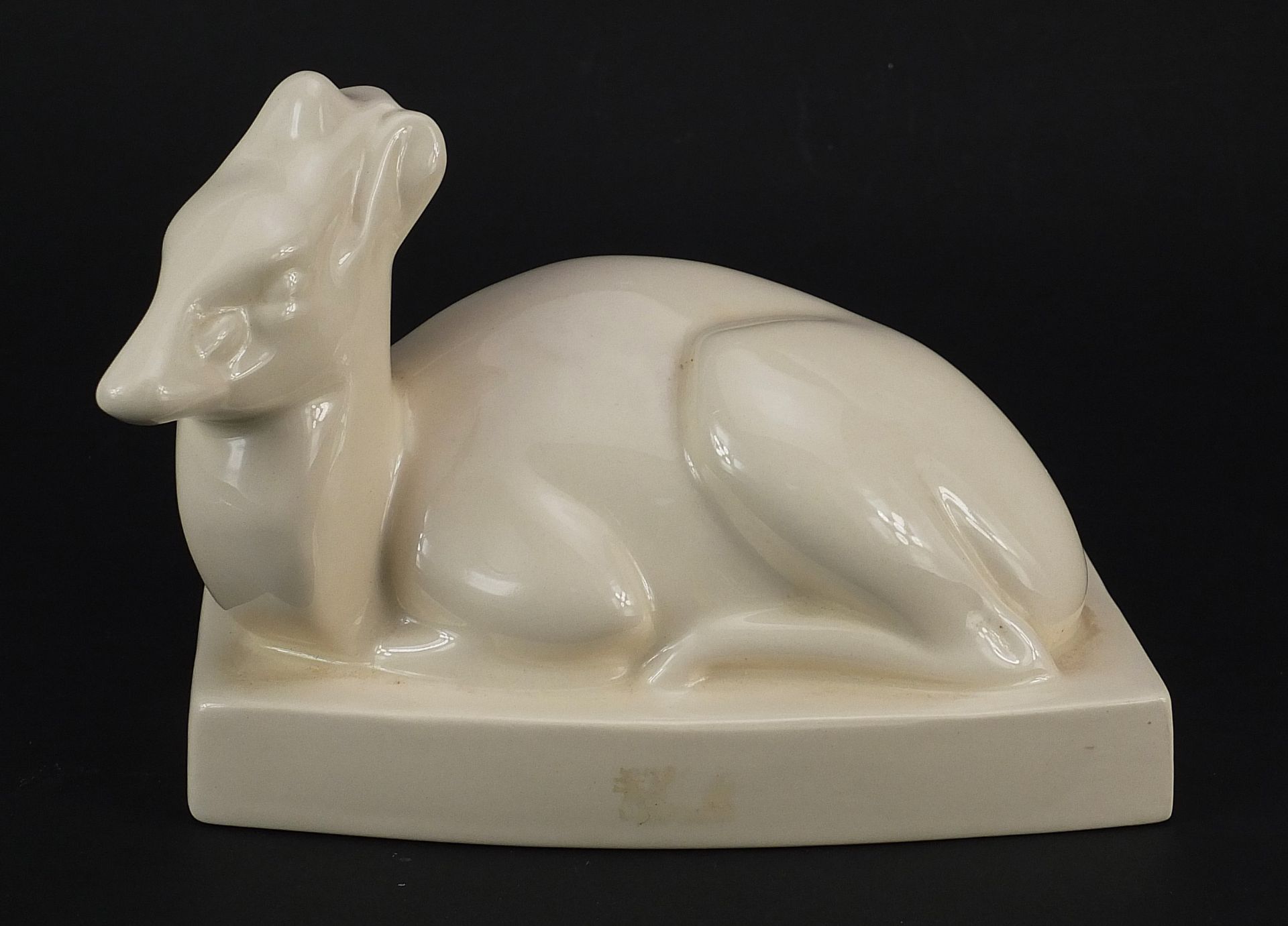 John Skeaping for Wedgwood, white glazed pottery recumbent deer, 17cm in length