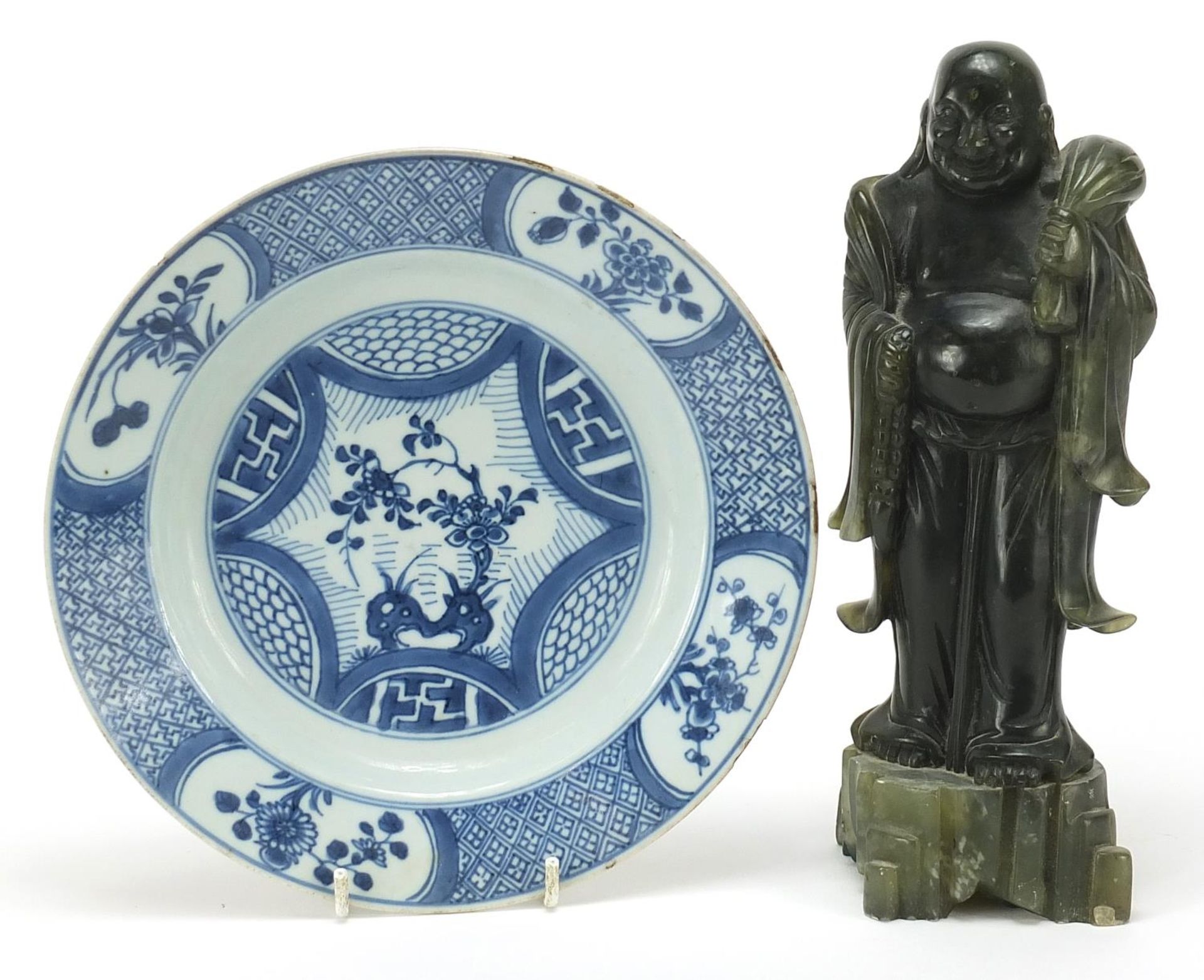 Chinese green stone carving of standing Buddha and a blue and white porcelain plate hand painted