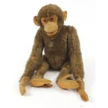 Large antique straw filled chimpanzee with articulated limbs, 70cm high