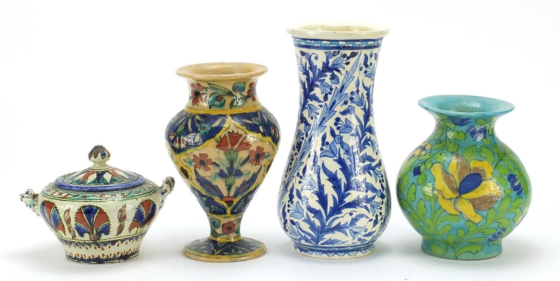 Palestinian pottery including three vases hand painted with flowers, the largest 20.5cm high