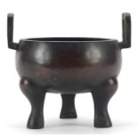 Chinese patinated bronze tripod incense burner with twin handles, character marks to the base,