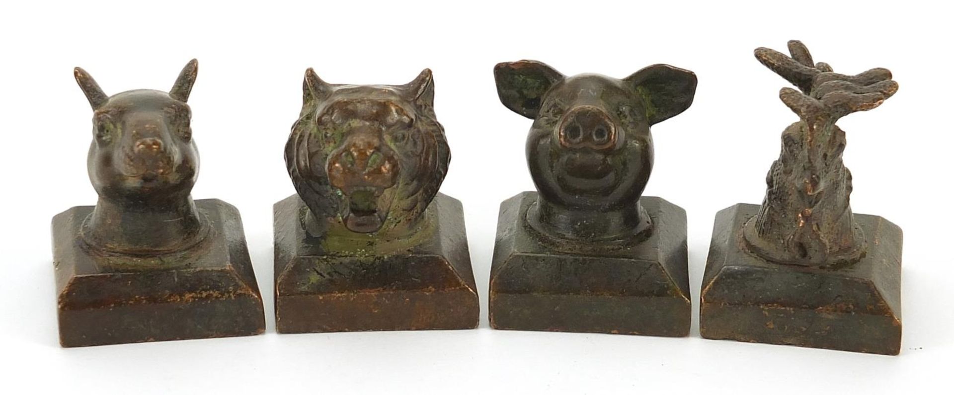 Four Chinese patinated bronze desk seals, the largest 4cm high