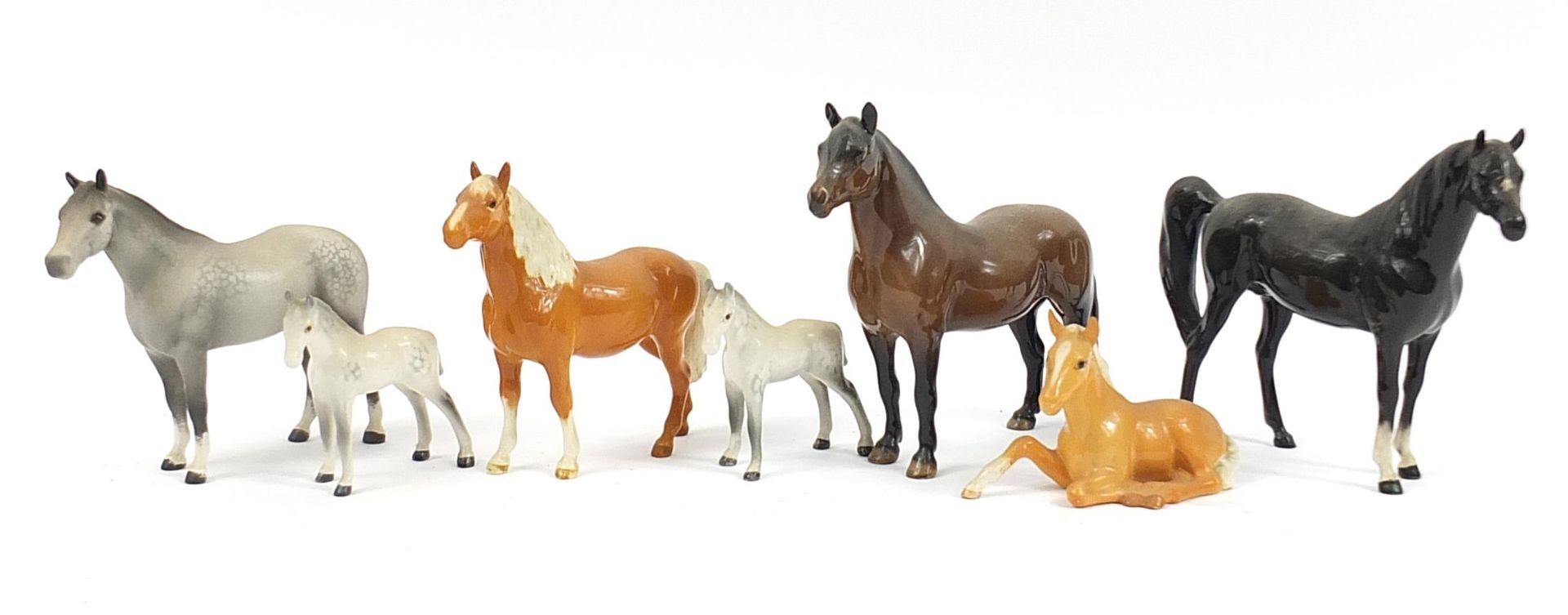 Seven Beswick horses including dapple grey and tan, the largest 20.5cm in length