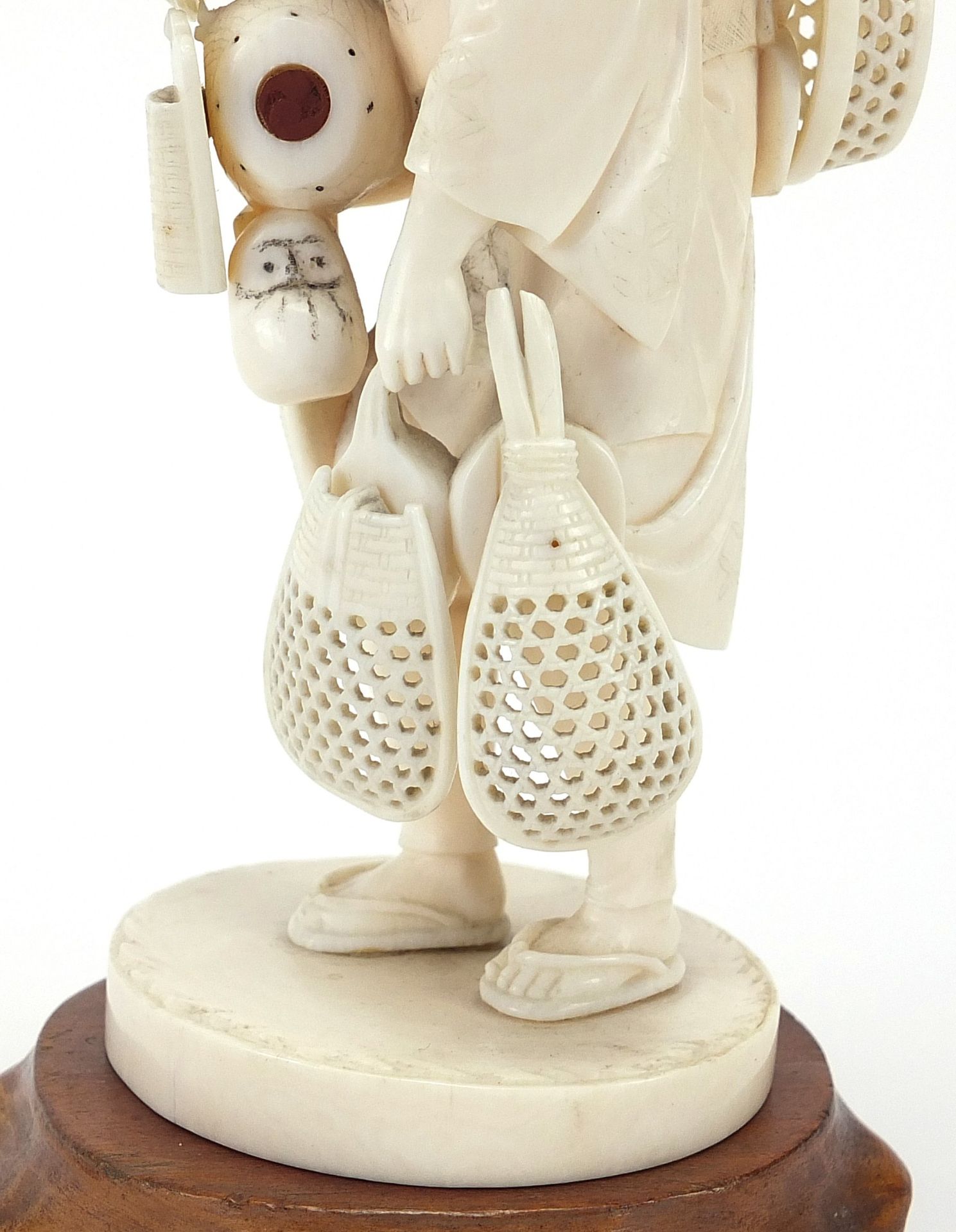 Good Japanese carved ivory okimono of a fisherman raised on a hardwood stand, inset red plaque - Image 3 of 9