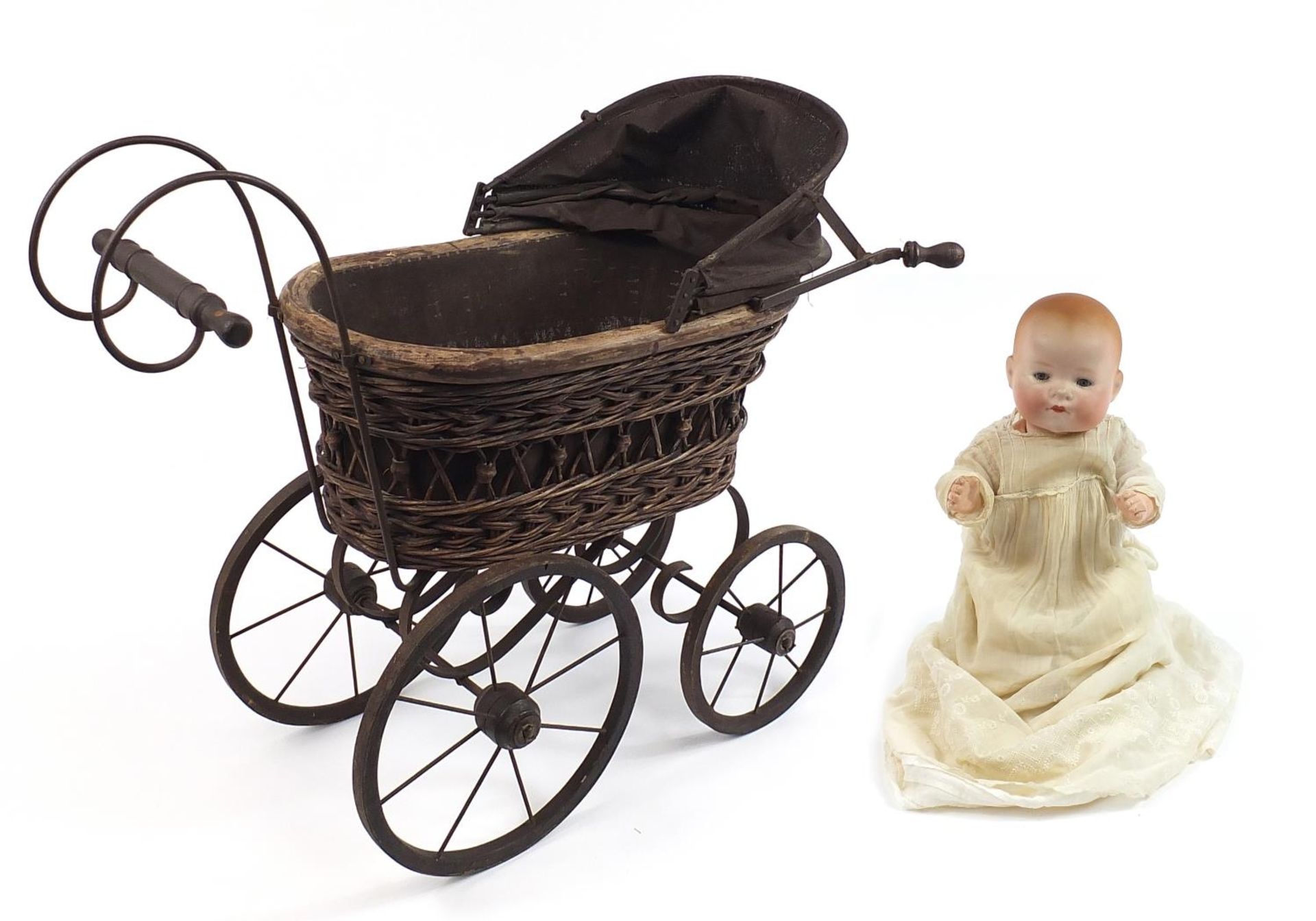 German Koppelsdorf bisque head doll with open close eyes and a Victorian doll's pram, 73cm in length